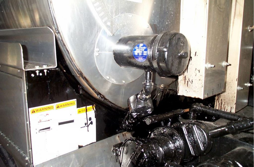 Heater sheaths create a drywell, inside which the actual heating elements reside. These sheaths are located toward the bottom of the tank, running along its length through the tank baffles. Controls for the heater are installed over the rear wheel fender.