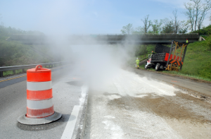 The use of hydrating lime, cement or fly ash chemical stabilization poses visibility hazards and airborne dry particulate emissions that asphalt emulsion-enabled FDR does not create. A chemical stabilizer, cement powder is spread on this pavement in advance of FDR, and you can clearly see the dry particulate emissions of reactive cement spreading into surrounding areas. FDR with asphalt emulsions precludes this problem. Photos courtesy Tom Kuennen.