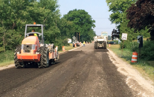 On Monroe County 151 in Michigan, the crew used an engineered asphalt emulsion for the FDR. A padfoot dirt roller—on the left—compacted the in-place recycled road base. Photo courtesy Asphalt Materials Inc.