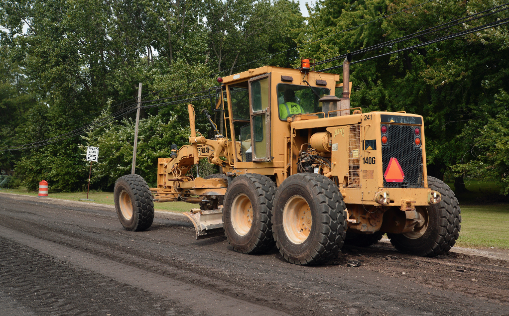 On Monroe County 151 in Michigan, the motor grader creates a crown on the newly stabilized subbase in advance of the asphalt surface course. Photo courtesy Asphalt Materials Inc.