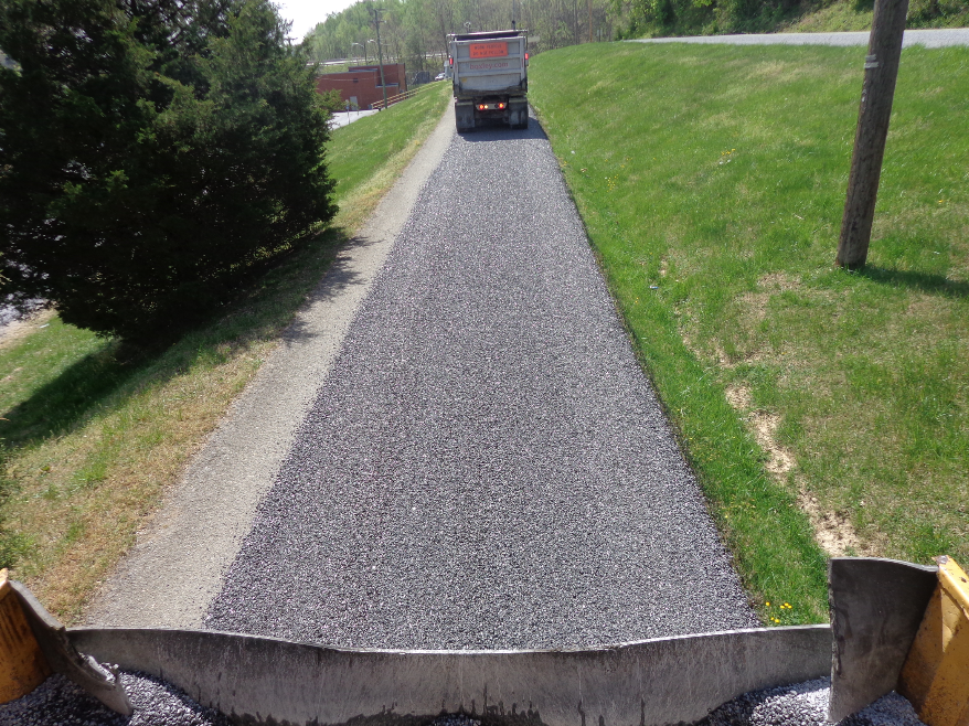 The completed roadway is ready for rolling to seat the chips.
