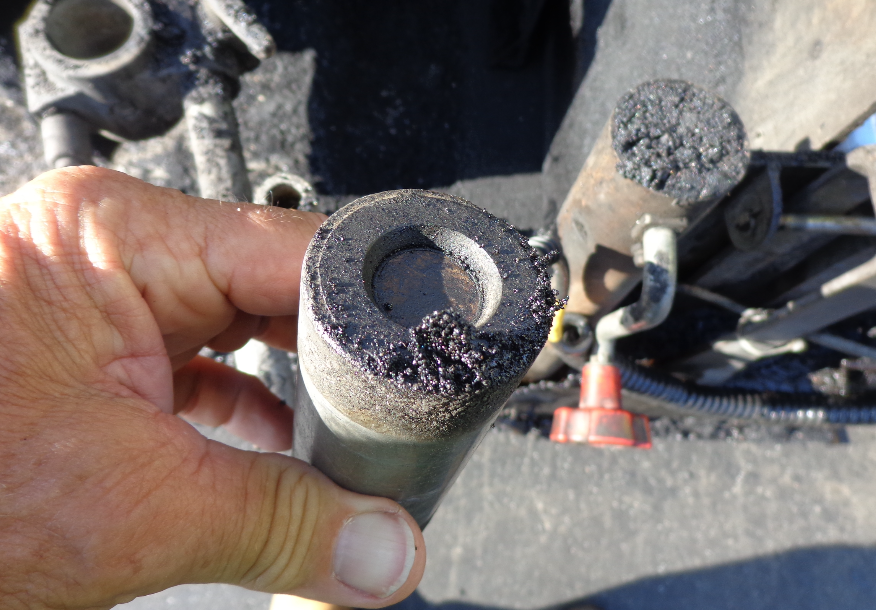 The inner circle of this tube is the ceramic feed sensor, which is supposed to be white. It can be replaced when it stops working, but that will cost the company anywhere from $1,500 to $2,000. Use brake cleaner to wipe this down at the end of each paving shift. Photo courtesy John Ball of Top Quality Paving.