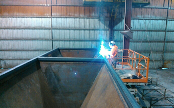 Rick Eddington welds the cold feed bins.