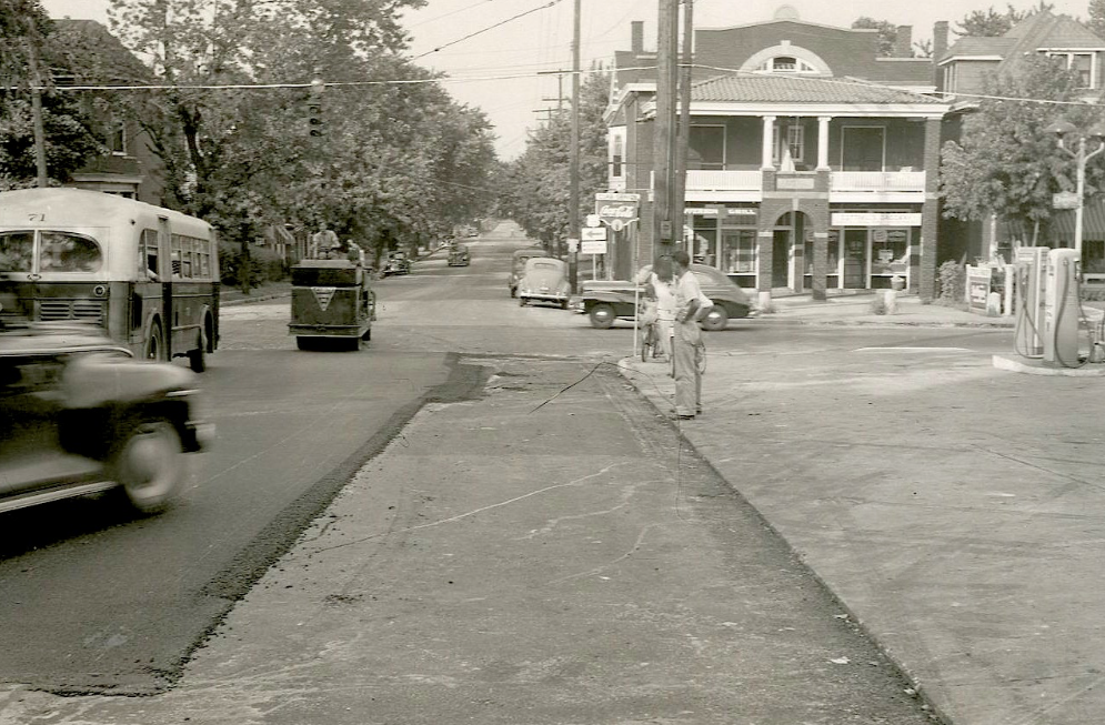 At the intersection of Third and Jefferson in August 1947, a hard-working crew placed shovelfuls of mix atop an interlayer to hold it in place for paving. Then motorists drove on the mat the roller operators were trying to compact.