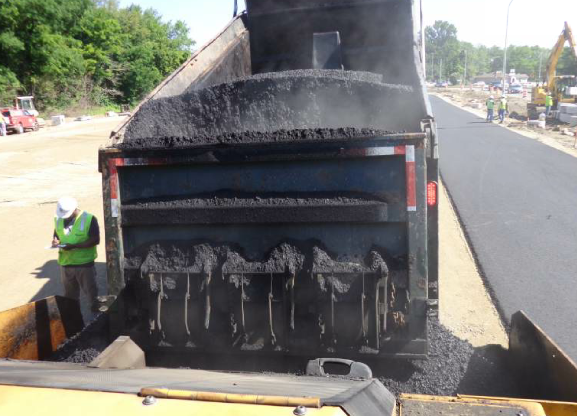 This driver, who will remain anonymous, did not align the body correctly under the silo for loadout. Luckily, he was positioned so that mix fell on the back end of the truck—and onto the scale where plant personnel had to bring in a skid steer for cleanup—and not on the cab. The cooled mix presents a hazard to drivers behind the truck and threatens material segregation when it falls into the hopper. While the driver has reflective tape along the top and sides of the back end for additional safety, that feature is partially hidden by his poor loadout skill and negligence. If you experience a slip-up at loadout, stop. You must stop and clean up any mess before you endanger motorists and yourself on the roadway.