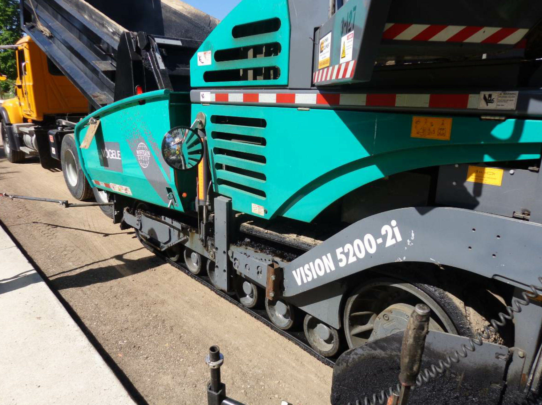 This team has attached an 8-inch convex mirror to a heavy duty, flat magnet so they can position the mirror for the paver operator’s benefit and the screed operator’s benefit. All photos courtesy John Ball, Top Quality Paving & Training, Manchester, New Hampshire.