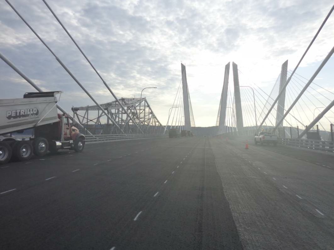 In this picture, you can see the old Tappan Zee Bridge components to the left being dismantled and barged away while the Tilcon team prepares the new spans for duty. The twin spans of the new cable-stayed Tappan Zee Bridge are each 3.1 miles long and 96 feet wide—each consisting of five traffic lanes, a shoulder and a bicycle/pedestrian lane. Photo courtesy John Ball.