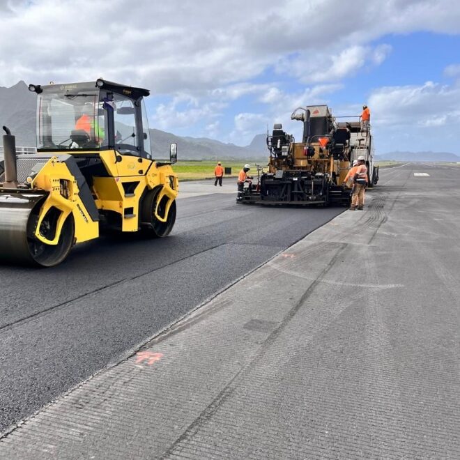 The breakdown roller on the project was a Bomag BW151AD tandem vibratory steel, the pneumatic tire roller was an Ammann AP240 ballasted to 26.45 tons, and the finish roller was a Hamm HD90 tandem vibratory steel drum roller.